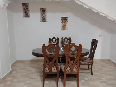 a dining room with a table and four chairs at Jasmine villa in Hurghada
