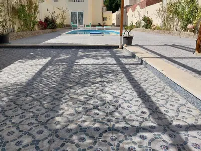 a cobblestone street with a shadow of a building at Jasmine villa in Hurghada