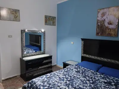 a bedroom with a bed and a mirror on the wall at Jasmine villa in Hurghada