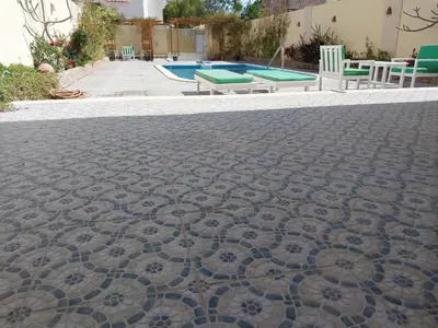 a tile floor with a pool in the background at Jasmine villa in Hurghada