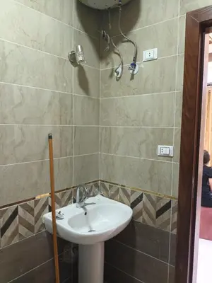 a bathroom with a sink and a shower at Cleopatra Resort F16 in Hurghada