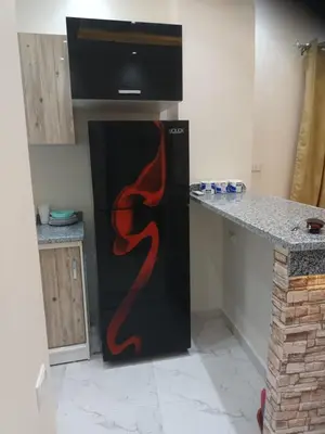 a kitchen with a black refrigerator with flames painted on it at Cleopatra Resort F16 in Hurghada