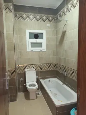 a bathroom with a toilet and a bath tub at Cleopatra Resort F16 in Hurghada