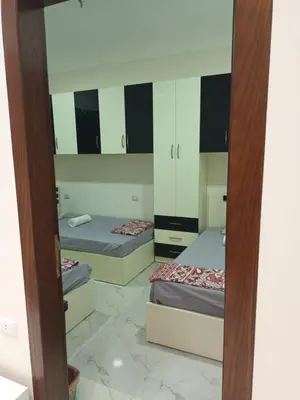 a room with two beds and a mirror at Cleopatra Resort F16 in Hurghada