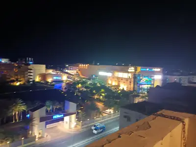 a city lit up at night with buildings and cars at Cleopatra Resort F16 in Hurghada