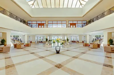 a large lobby with couches and a large ceiling at Sunrise Alma Bay Resort in Hurghada