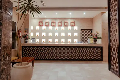 a restaurant with a counter with vases on the wall at Royal Star Beach Resort in Hurghada