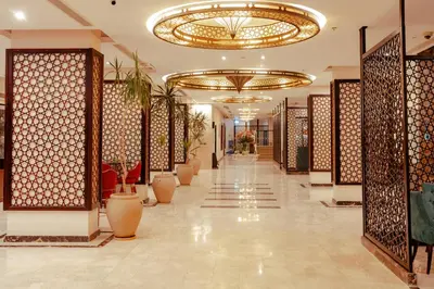a hallway in a hotel with a large chandelier at Royal Star Beach Resort in Hurghada