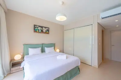 a bedroom with a large bed with white sheets at Mangroovy 2 Bedroom Sea View Apartment, Pool & Beach in Hurghada