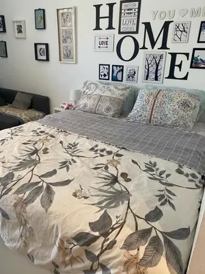 a bedroom with a bed with a comforter on it at G-Cribs gouna in Hurghada