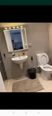 a bathroom with a sink and a toilet and a mirror at G-Cribs gouna in Hurghada