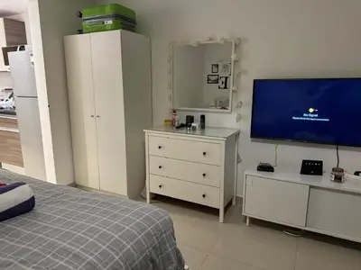 a bedroom with a bed and a flat screen tv at G-Cribs gouna in Hurghada