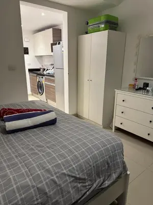 a bedroom with a bed and a kitchen at G-Cribs gouna in Hurghada