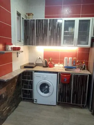 a kitchen with a washing machine in a kitchen at Apartment near the sea in Hurghada