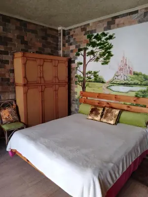 a bedroom with a bed with a painting on the wall at Apartment near the sea in Hurghada