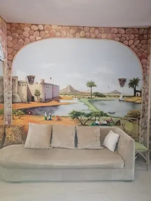 a living room with a couch in front of a mural at Apartment near the sea in Hurghada
