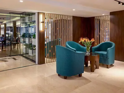 a lobby with two blue chairs and a table at Mövenpick Royal Lily Nile Cruise, Every Monday Four Nights From Luxor, Every Friday Three Nights From Aswan - Including Excursions & Sightseeing in Luxor