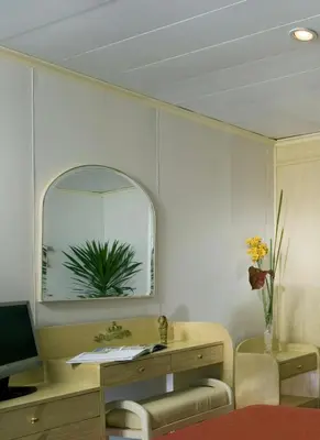 a room with a desk and a mirror on a wall at Mövenpick Prince Abbas Lake Nasser Cruise, Every Monday Four Nights From Aswan, Every Friday Three nights From Abu-Simbel - Including Excursions and Sightseeing in Aswan