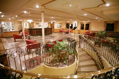 a building with a lobby with tables and chairs at Mövenpick Prince Abbas Lake Nasser Cruise, Every Monday Four Nights From Aswan, Every Friday Three nights From Abu-Simbel - Including Excursions and Sightseeing in Aswan