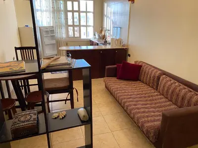 a living room with a couch and a table at PORTO HILL in Hurghada