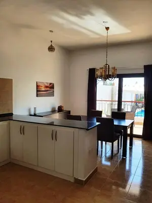 a kitchen with a table and a dining room at CASA LOKO Guest House in Luxor