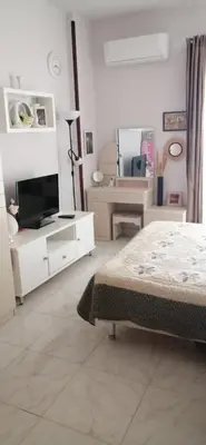 a bedroom with a bed and a tv on a dresser at Studio in compaund in Hurghada
