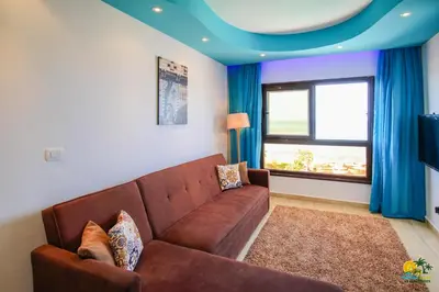a living room with a brown couch and a blue ceiling at All View Apartements Hurghada in Hurghada