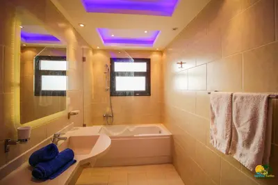 a bathroom with a tub and a sink and a toilet at All View Apartements Hurghada in Hurghada