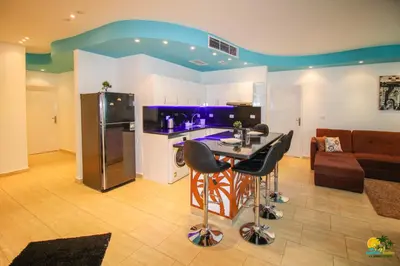 a kitchen and living room with a table and a couch at All View Apartements Hurghada in Hurghada