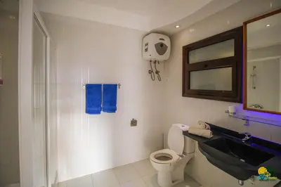 a bathroom with a toilet and a sink and a mirror at All View Apartements Hurghada in Hurghada