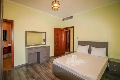 a bedroom with a bed with a dresser and a television at Sahl Hasheesh, El Andalous by All View apartements in Hurghada