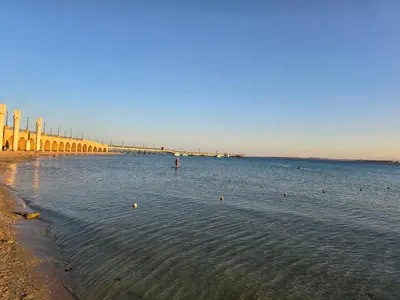 a large body of water with a bridge in the background at Sahl Hasheesh, El Andalous by All View apartements in Hurghada