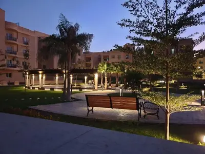 a park with a bench and trees and buildings at Luxury Aqua Tropical Resort Next To Al Gouna 4 0 1 in Hurghada
