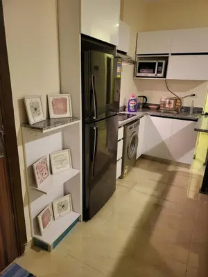 a kitchen with a refrigerator and a dishwasher at Luxury Aqua Tropical Resort Next To Al Gouna 4 0 1 in Hurghada