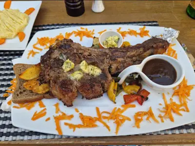 a plate of food with meat and vegetables on a table at Luxury Aqua Tropical Resort Next To Al Gouna 4 0 1 in Hurghada
