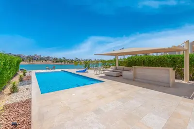 a swimming pool with a gazebo next to a swimming pool at Joubal Lagoon II 4-Bedroom Villa with Private Pool & Lagoon Views in Hurghada