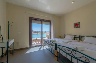 a bedroom with a bed and a view of the ocean at Joubal Lagoon II 4-Bedroom Villa with Private Pool & Lagoon Views in Hurghada