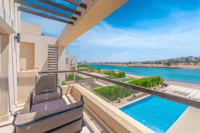 a view of the pool from the balcony of a house at Joubal Lagoon II 4-Bedroom Villa with Private Pool & Lagoon Views in Hurghada