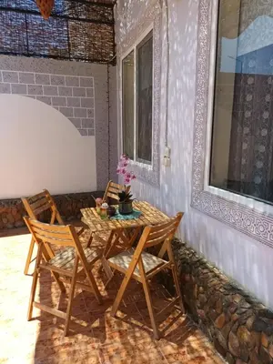 a table and chairs on the porch of a house at Rum i villa med pool in Hurghada