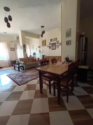 a living room with a wooden table and chairs at Rum i villa med pool in Hurghada