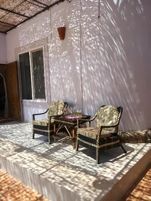 two chairs and a table on a patio at Rum i villa med pool in Hurghada