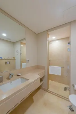 a bathroom with a sink and a glass shower at Elegant 2-Bedroom Apartment in Mangroovy, Pool & Beach in Hurghada
