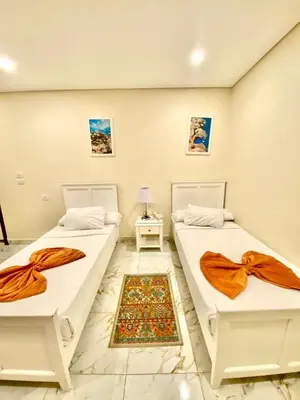 two beds sitting next to each other in a room at Tiba Rose hurghada in Hurghada