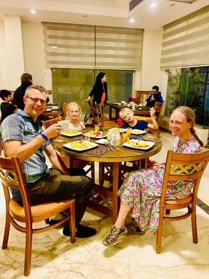 a group of people sitting at a table in a restaurant at Tiba Rose hurghada in Hurghada