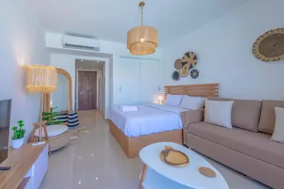 a living room with a bed and a couch at Boho-Chic Studio Apartment in G-Cribs, Pool View in Hurghada