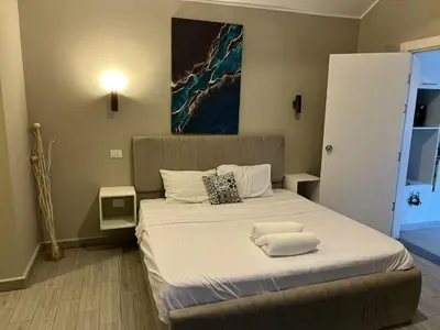 a bedroom with a bed with two towels on it at Lovely 1BR with Private Heated pool at El-Gouna in Hurghada