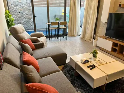 a living room with a couch and a table at Lovely 1BR with Private Heated pool at El-Gouna in Hurghada