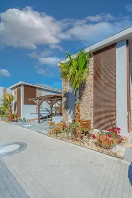 a building with a palm tree in front of it at Lovely 1BR with Private Heated pool at El-Gouna in Hurghada