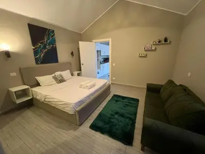 a small bedroom with a bed and a couch at Lovely 1BR with Private Heated pool at El-Gouna in Hurghada