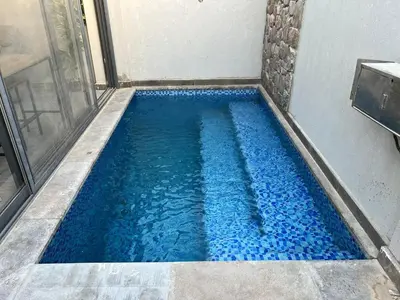 a swimming pool with blue water in a shower at Lovely 1BR with Private Heated pool at El-Gouna in Hurghada